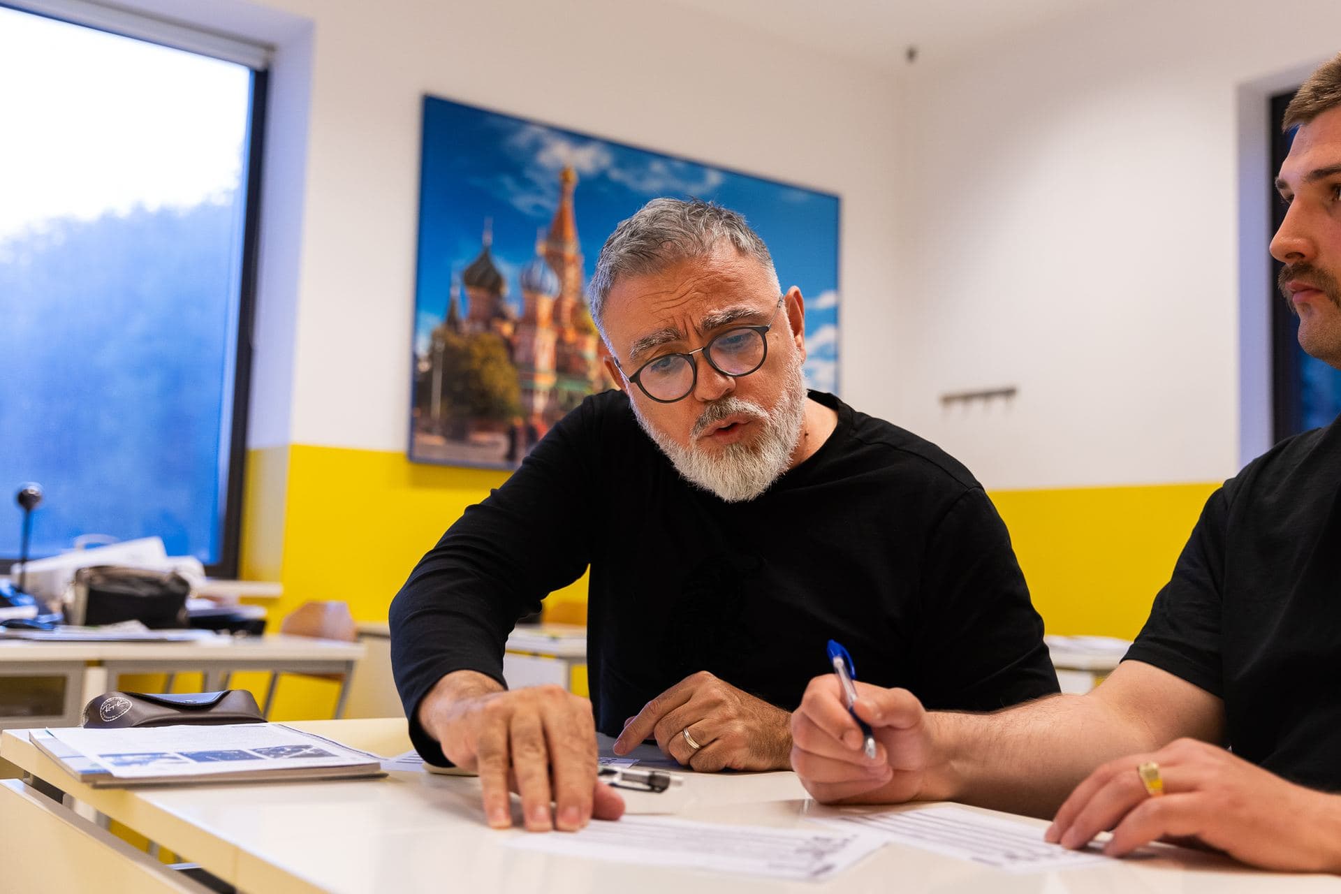 A teacher writing during an English course
