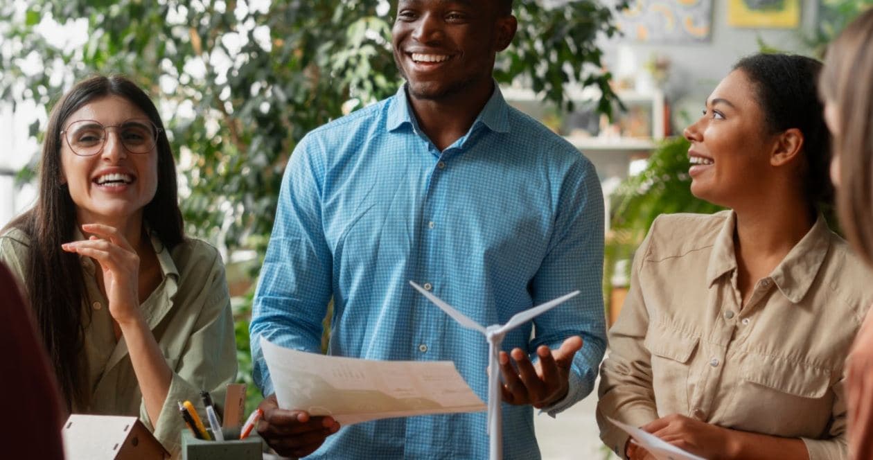 Teachers with a model wind turbine